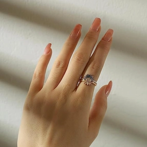 Rose gold celestial ring set with sun moon motifs and sparkling blue cubic zirconia