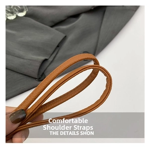 Détail de la bandoulière en cuir PU marron montrant la texture douce et le grain