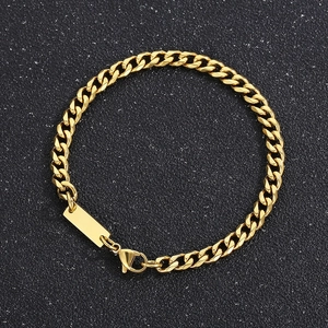 Macro shot of gold-plated Cuban link bracelet featuring a polished rectangular metal plate