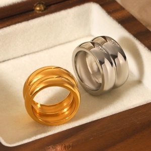 Detailed close-up of gold and silver double-layer mirror polished stainless steel rings
