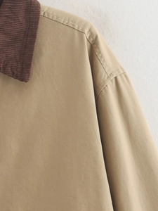 Detail of contrast brown corduroy collar and khaki knit fabric with neat double stitching