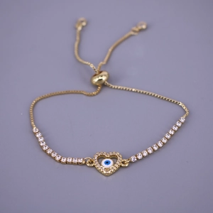 Close-up of golden heart evil eye bracelet with white zircon and adjustable chain