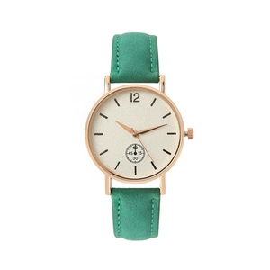 Minimalist quartz watch with dark green suede leather strap and rose gold case on white backdrop