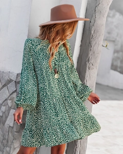 Detail showing the green white polka dot layered dress with long sleeves and tiered design
