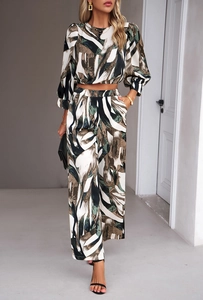 Detail view of the abstract print pattern on long-sleeved crop top and wide-leg trousers