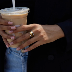 Detail of two-tone layered stainless steel wide ring in a modern everyday lifestyle setting