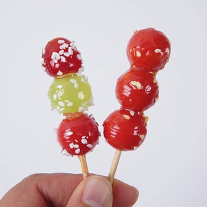 Realistic sugar-coated hawthorn hair clips with sesame seeds on white background