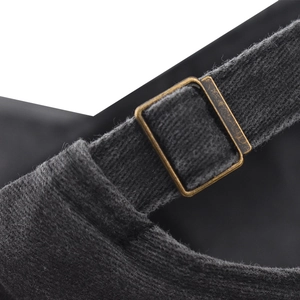 Detailed macro view of the vintage bronze metal buckle on a dark grey washed cotton baseball cap