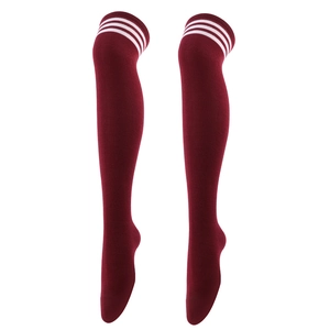 Detail view of burgundy over-knee socks with white triple stripes on knitted fabric