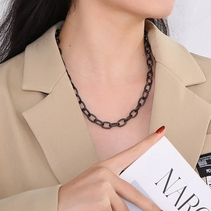 Close-up of stylish black titanium steel chain necklace with O-ring clasp on model