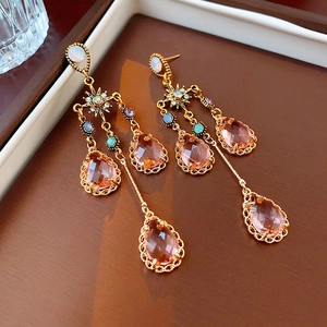 Luxurious gold star drop earrings with pink water drop crystals and long tassels