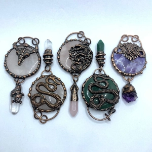 Retro bronze pendants featuring carved dragons and snakes with natural crystal quartz stones