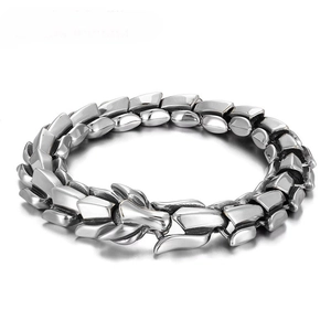 Macro shot of silver dragon link chain bracelet with a detailed dragon head clasp