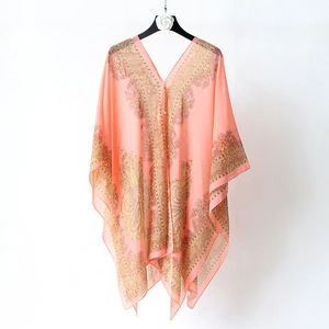 Detail of pink chiffon silk scarf with floral print and V-neckline on white hanger