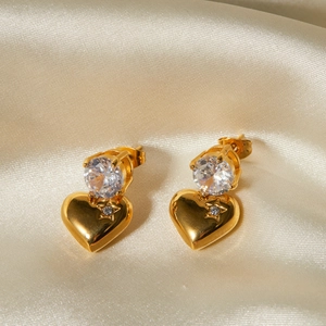 Detail of 18k gold plated heart earrings with sparkling zircon and star engraving