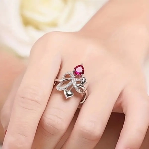 Silver hollow ring with heart-cut red gemstone and delicate pavé diamond accents