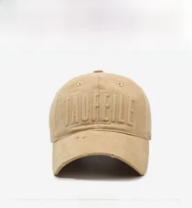 Close-up of distressed khaki baseball cap with 3D letter embroidery and vintage frayed brim