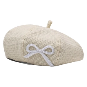 Chic beige beret for women featuring an elegant white embroidered bow detail