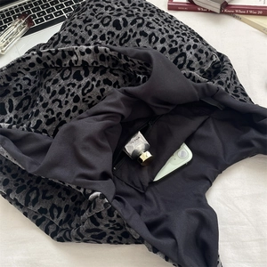 Internal view of the leopard print tote bag with black lining and secure zipper pocket