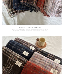 Detailed view of colorful checkered scarves with frayed edges and soft texture