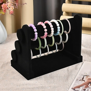 Detailed view of black velvet 3-tier jewelry display stand for bracelets and watches