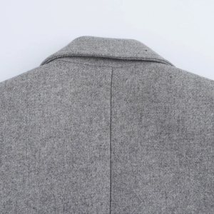 Detail shot of the back collar and shoulder stitching on a grey wool-blend coat
