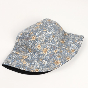 Detail of floral bucket hat featuring light blue daisy print and black inner lining