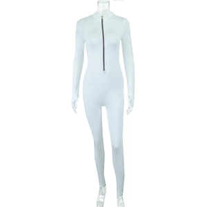 Detail of white long sleeve bodysuit with stand collar, front zipper, and thumbhole cuffs