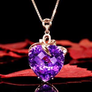 Detail of heart-shaped amethyst pendant with rose gold finish and diamond accents