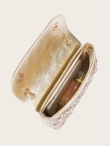Interior view of gold evening bag with 3D floral embellishments and metal chain strap
