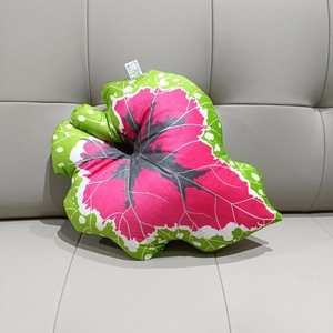 Macro shot of bionic Caladium leaf pillow showing realistic pink and green plush texture