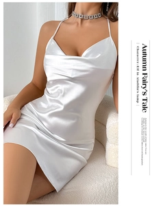 Close-up of elegant white satin slip dress featuring a draped deep V-neckline and smooth silk texture