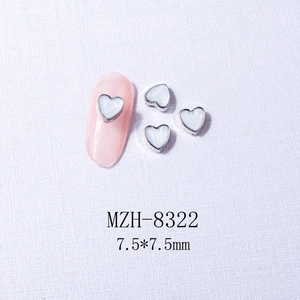 Macro detail of heart nail charms with silver metal edges and white marble texture, 7.5mm