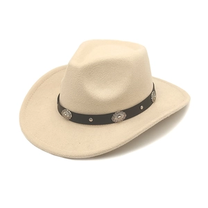 Detail of beige felt cowboy hat with silver studs and vintage engraved metal conchos