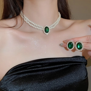 Elegant jewelry set with double-layer pearl necklace and green oval gemstone earrings