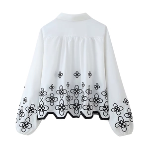 White long sleeve shirt with black floral embroidery and scalloped hem back view