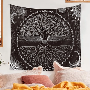 Detail of bohemian tree of life tapestry with celestial sun and moon patterns on black fabric