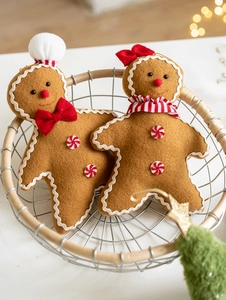 Detail of plush gingerbread man Christmas tree ornaments with festive red and white accessories