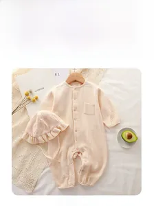 Detail of infant long-sleeve cotton gauze romper set with ruffled sun hat in beige