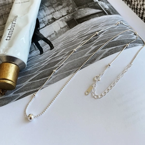 Macro shot of 925 sterling silver bead chain necklace with polished sphere detail