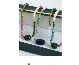 Macro shot of colorful faceted natural stone beaded bracelets with gold metal accents