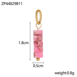 Detailed view of pink textured cylindrical beads with gold metal loop jewelry charms