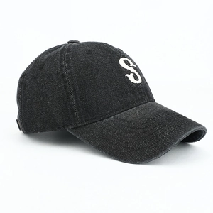 Detailed view of vintage washed black denim baseball cap with white embroidered S letter