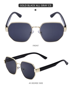 Detail view of gold geometric sunglasses with dark gray lenses and metal frame temple info