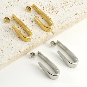 Boucles d'oreilles minimalistes en forme de U en or et argent sur pierre de travertin