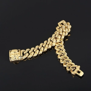 Detailed view of gothic skull clasp and gold-plated links on a biker steel bracelet
