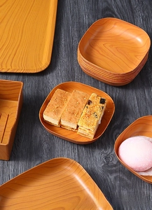 Macro shot of assorted wood grain serving trays with various sizes and elegant shapes