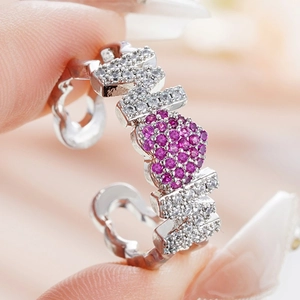 Close-up of MOM heart ring with pink zircon on hand for Mother's Day gift