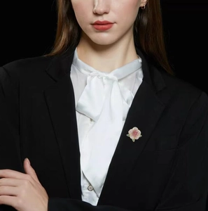 Exquisite camellia brooch with colorful crystals pinned on a black formal suit lapel
