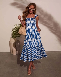 Detail of blue and white geometric print dress with square neck and pleated bodice